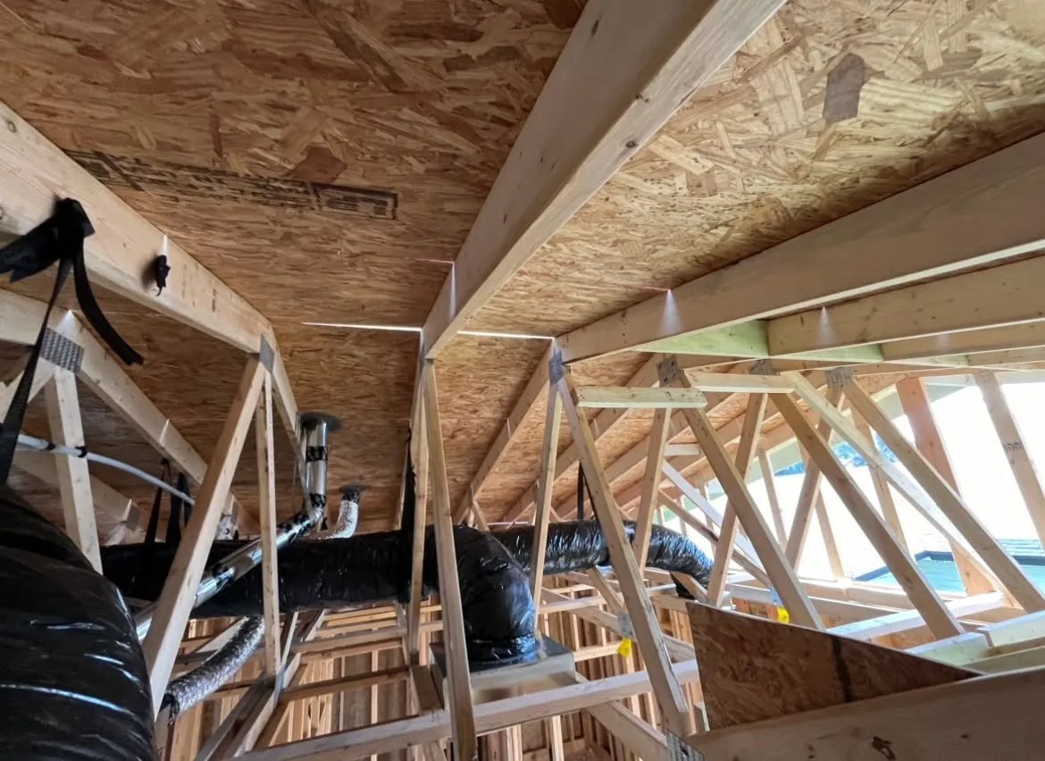 Flex duct and boots laid through the trusses of a new build