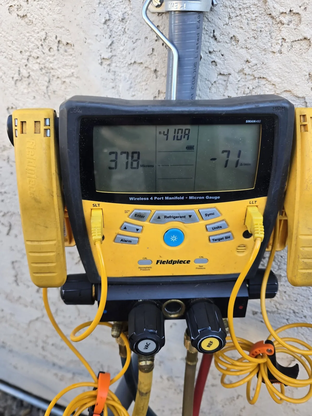 Digital refrigerant gauges hooked to a condenser
