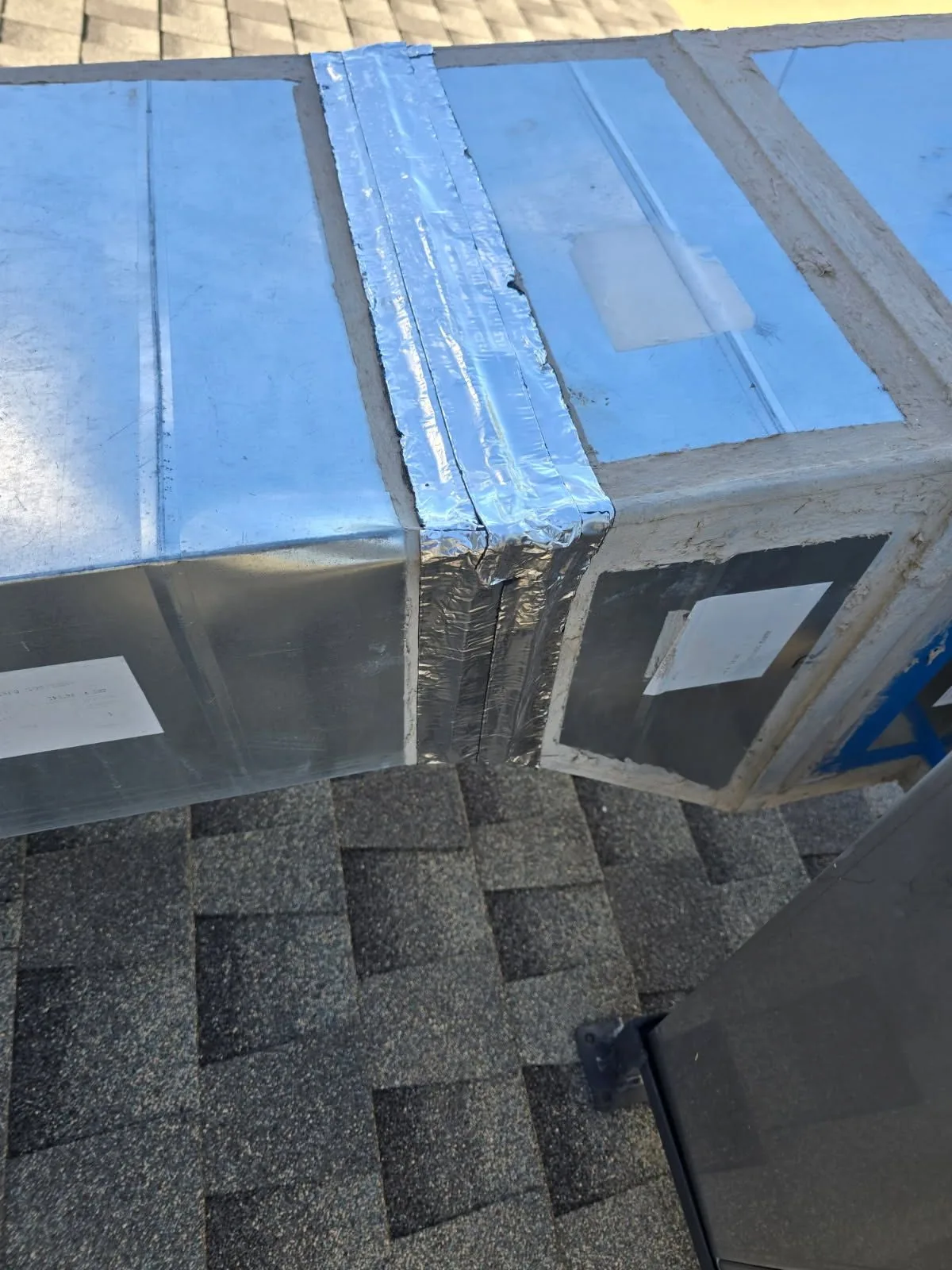 Sealed supply and return ductwork on a shingle roof