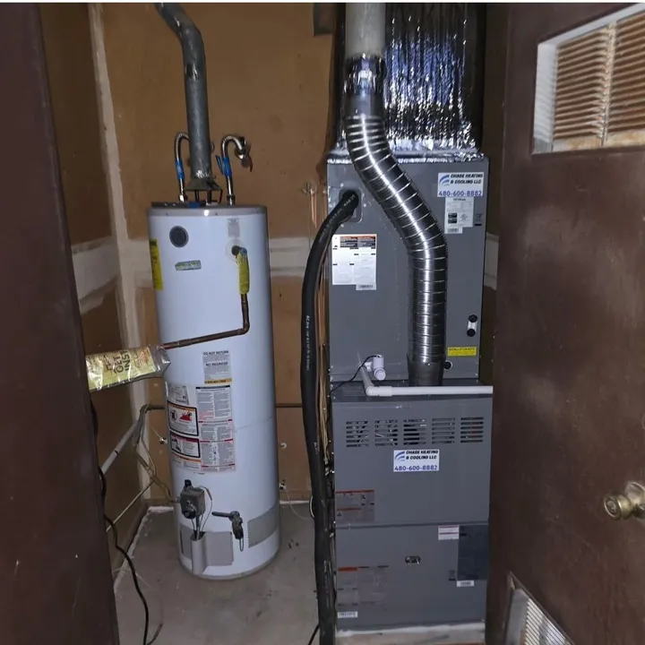 Furnace and water heater side by side in a utility closet