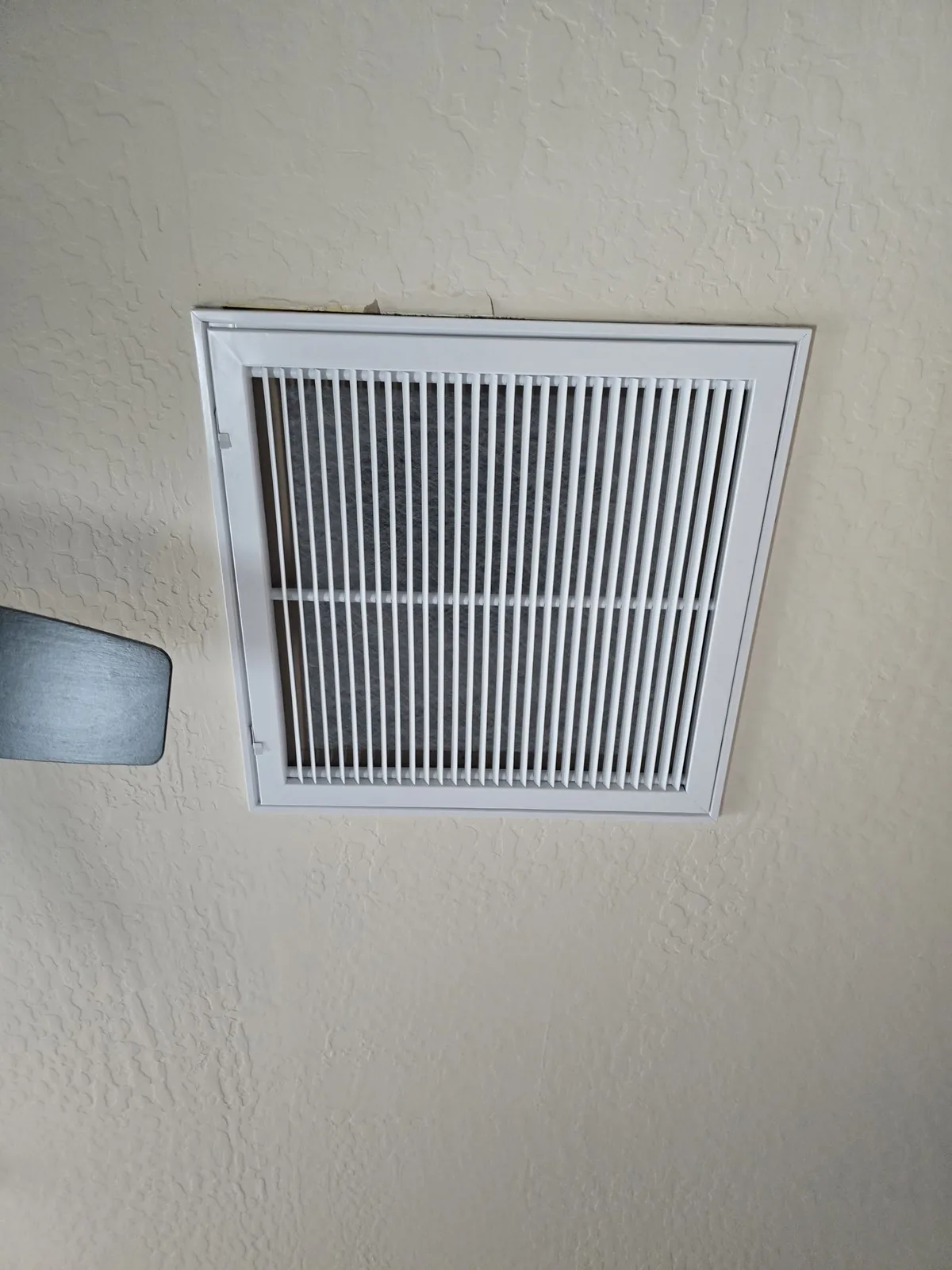 New return air grille on a hallway wall