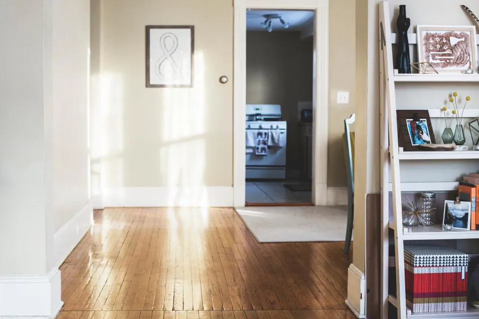 Bright hallway with wood floors and an open doorway